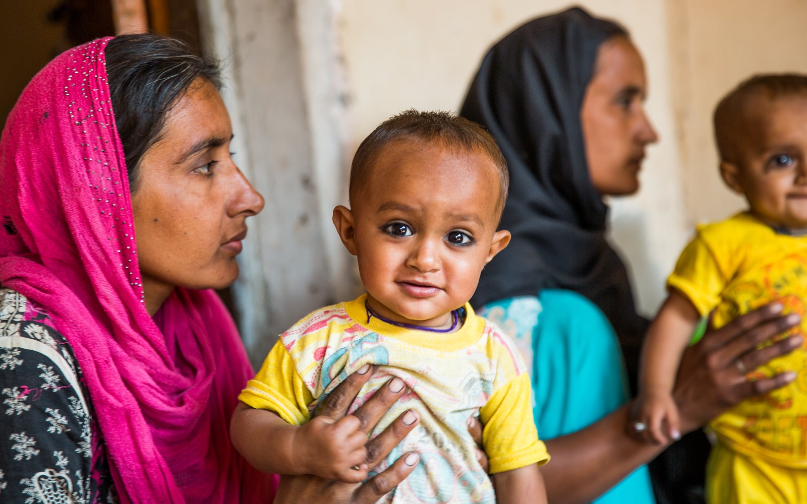 A mother in Bangladesh feeding her child solid food to complement breastfeeding.