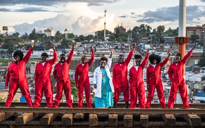 Dr. Stellah Bosire (middle) walks along the railroad tracks with the members of the Feminist for Peace, Rights, and Justice Center (FPRJC) in Kibera, Nairobi, Kenya.