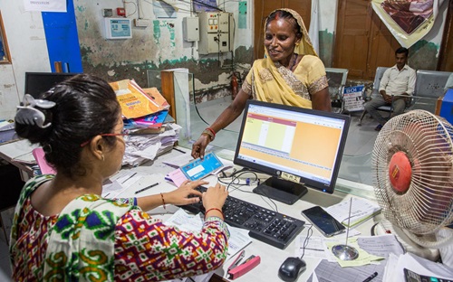 Shrimati, a beneficiary of zero-balance Jan Dhan bank account carries out a transaction at the bank in Targaon village in Unnao district of Uttar Pradesh, India on August 5, 2019.