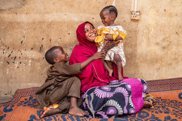 9-month-old Hafsat Abubakar is held by her mother, Safiya Ibrahim, at their home in the Sarkin Adar Gidan Igwai neighbourhood of Sokoto. Hafsat’s older brother, Ismail, sits with them