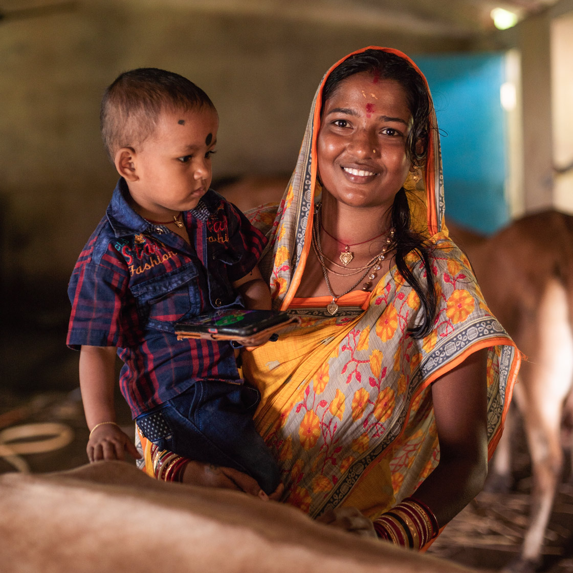 Portrait of Elena Swain, daughter of  Goalkeeper, Sushama Das, with her son, Sraboni, in Astaranga Village, Odisha State, India.